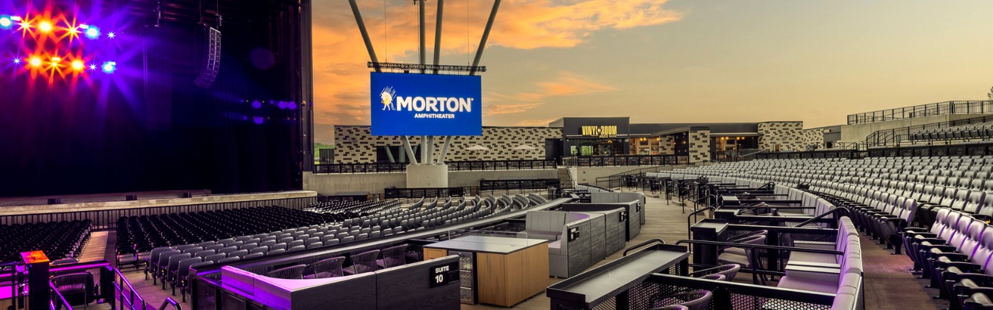 Interior view of Morton Amphitheater at sunset with the stage, seating, and venue screen
